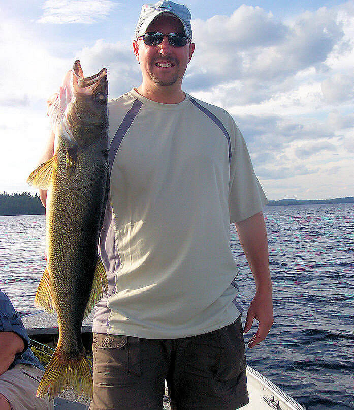 Garden Island Lodge angler holding trophy Ontario walleye for a picture before releasing it.
