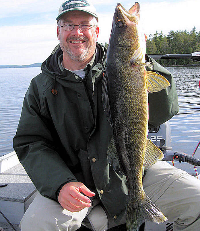 Fisherman holding trophy Lady Evelyn Lake walleye for a picture.