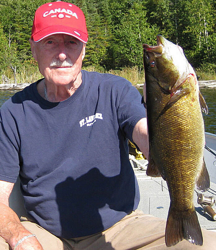 Fisherman catches trophy Ontario smallmouth bass.
